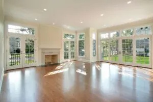 Large room with wood floors and multiple glass doors