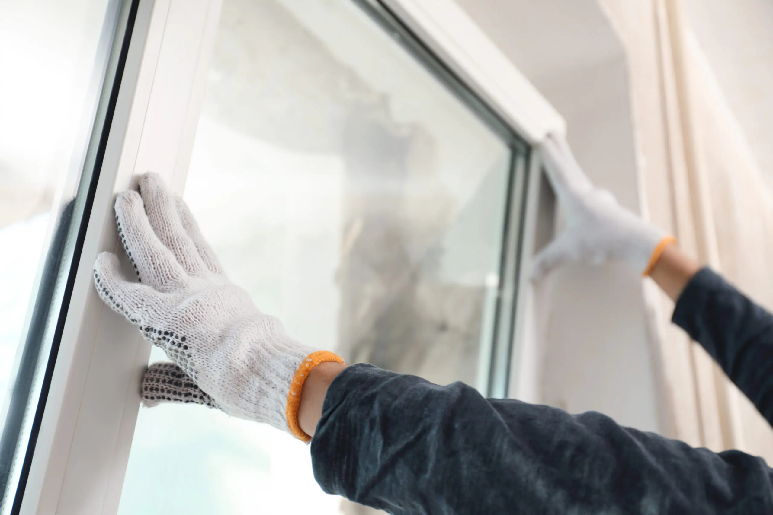 A close view of a professional installer replacing a window