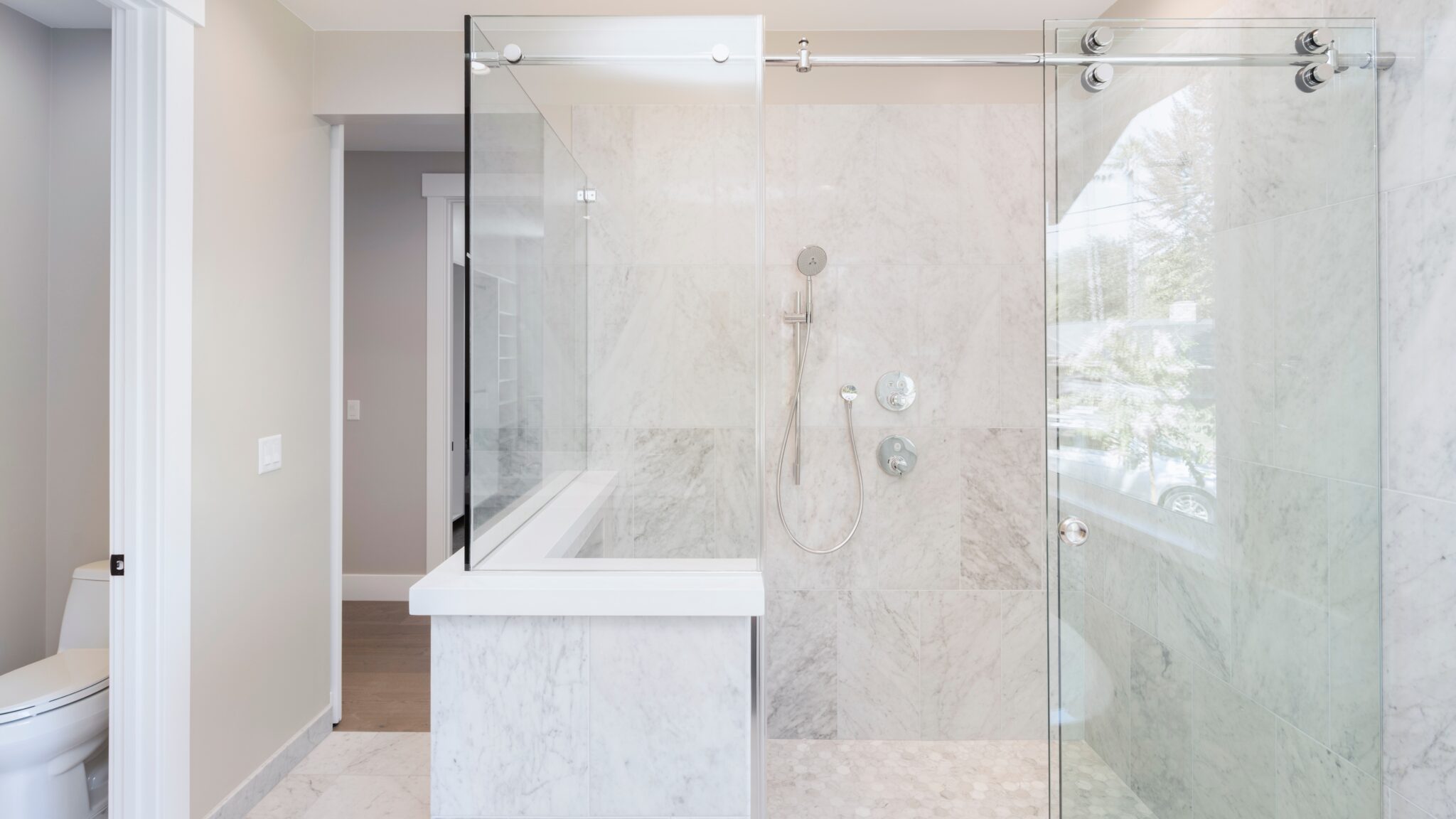 Brand new glass shower door installed by GoGlass in white tiled bathroom in Dover DE