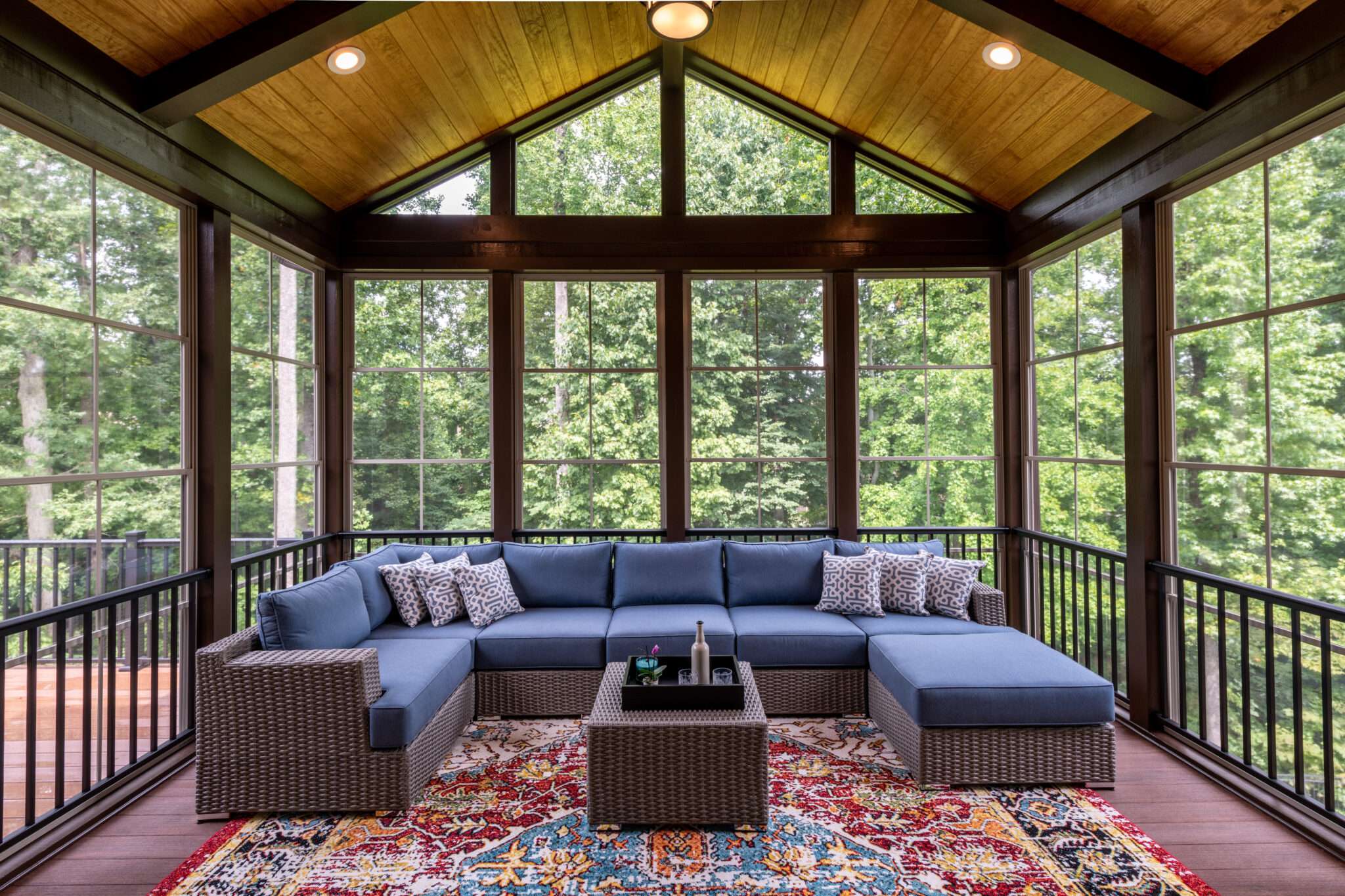 Glass sunroom with large windows and vaulted wood ceiling