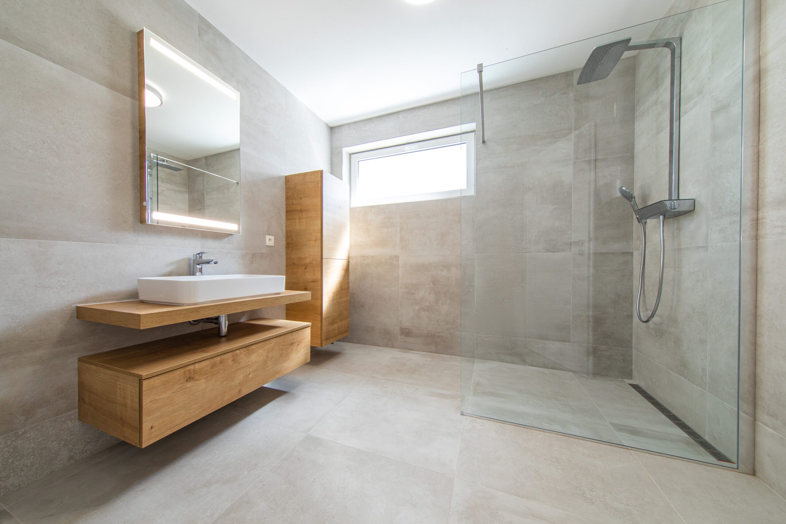 Simple, clear glass in bathroom with silver waterfall showerhead