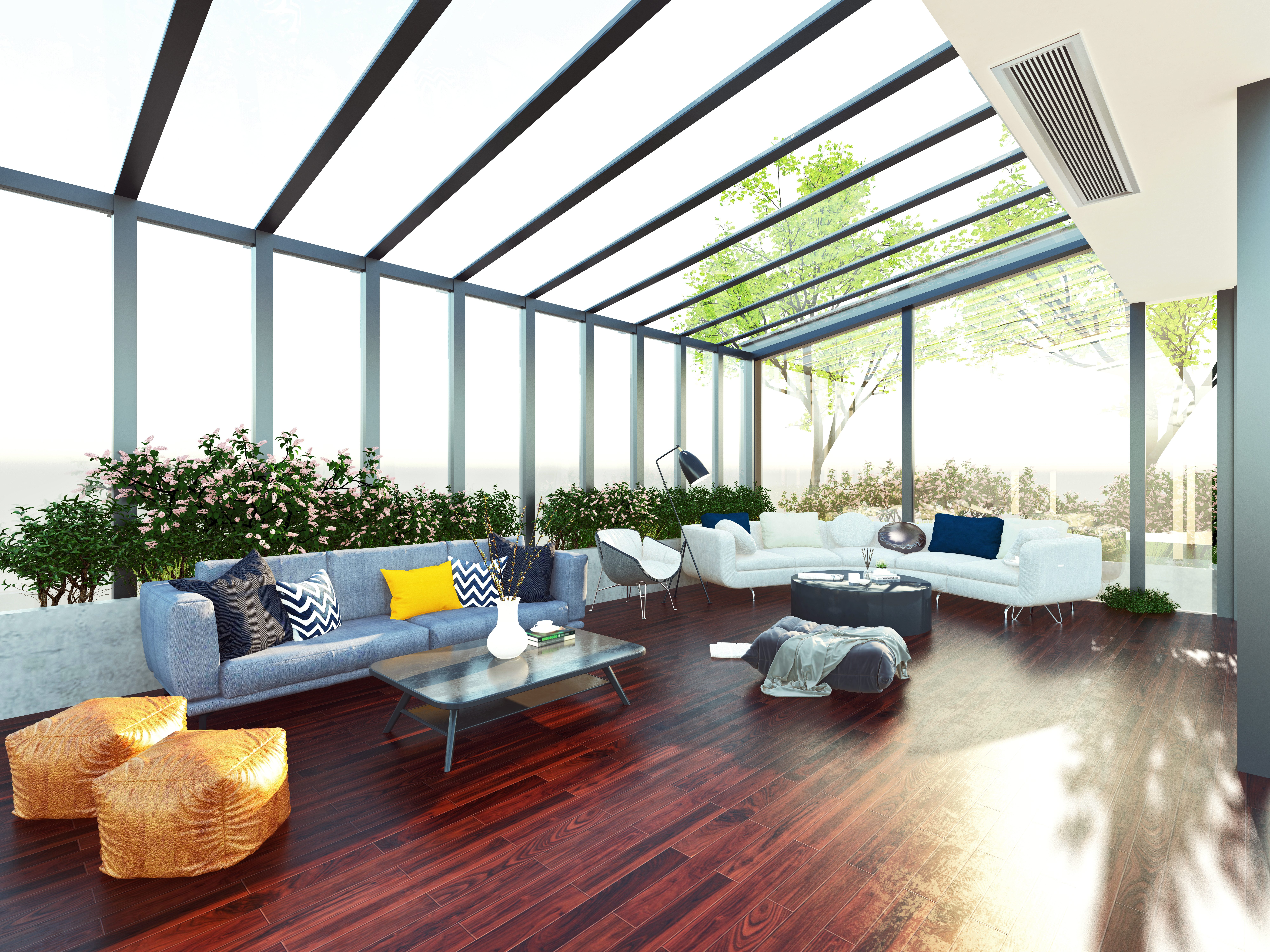 Greenhouse-like sunroom with large windows and living room furniture