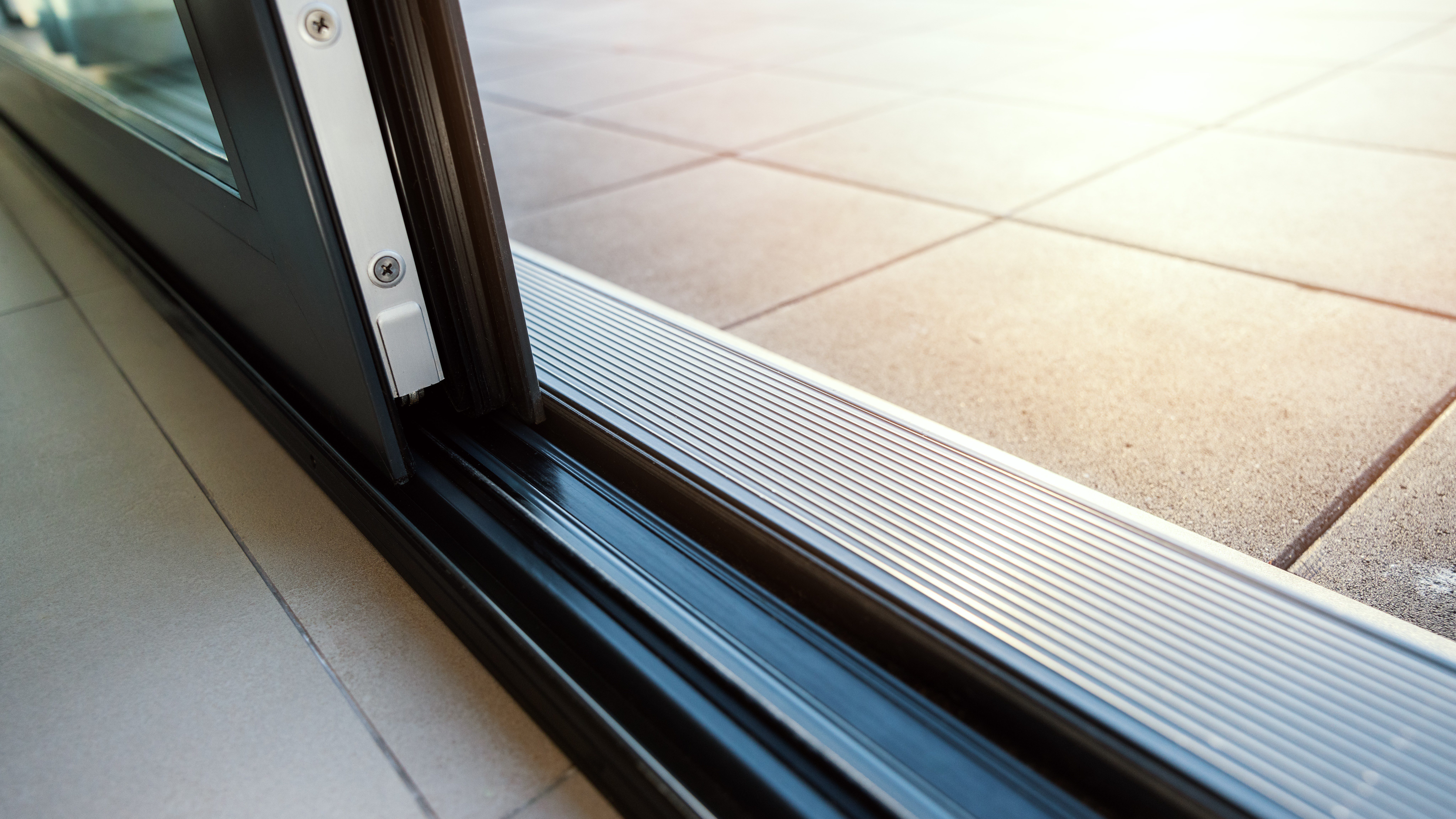 Close-up view of a sliding glass door and its track