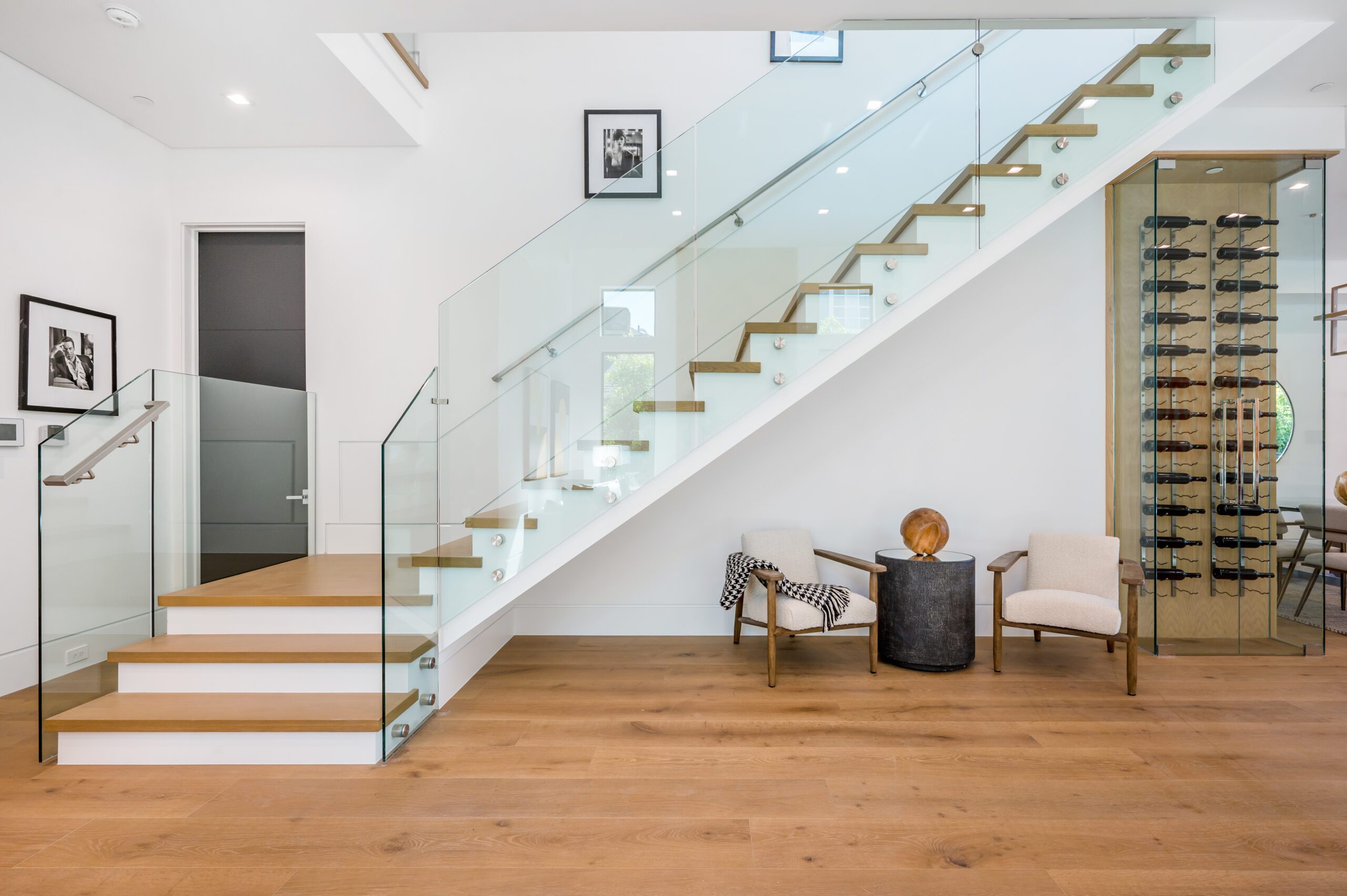 There is a staircase with a glass railing