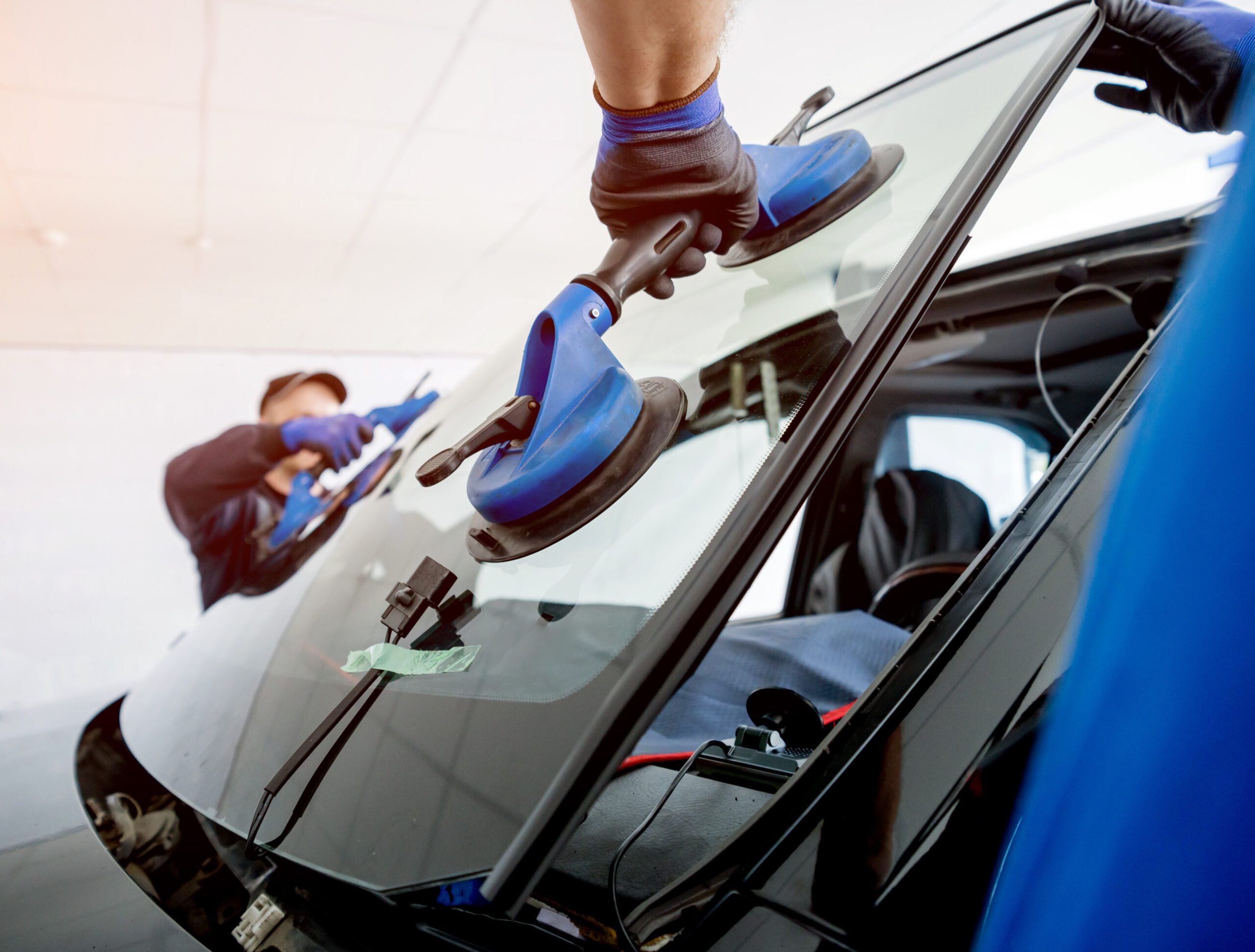 A windshield is being applied to the car