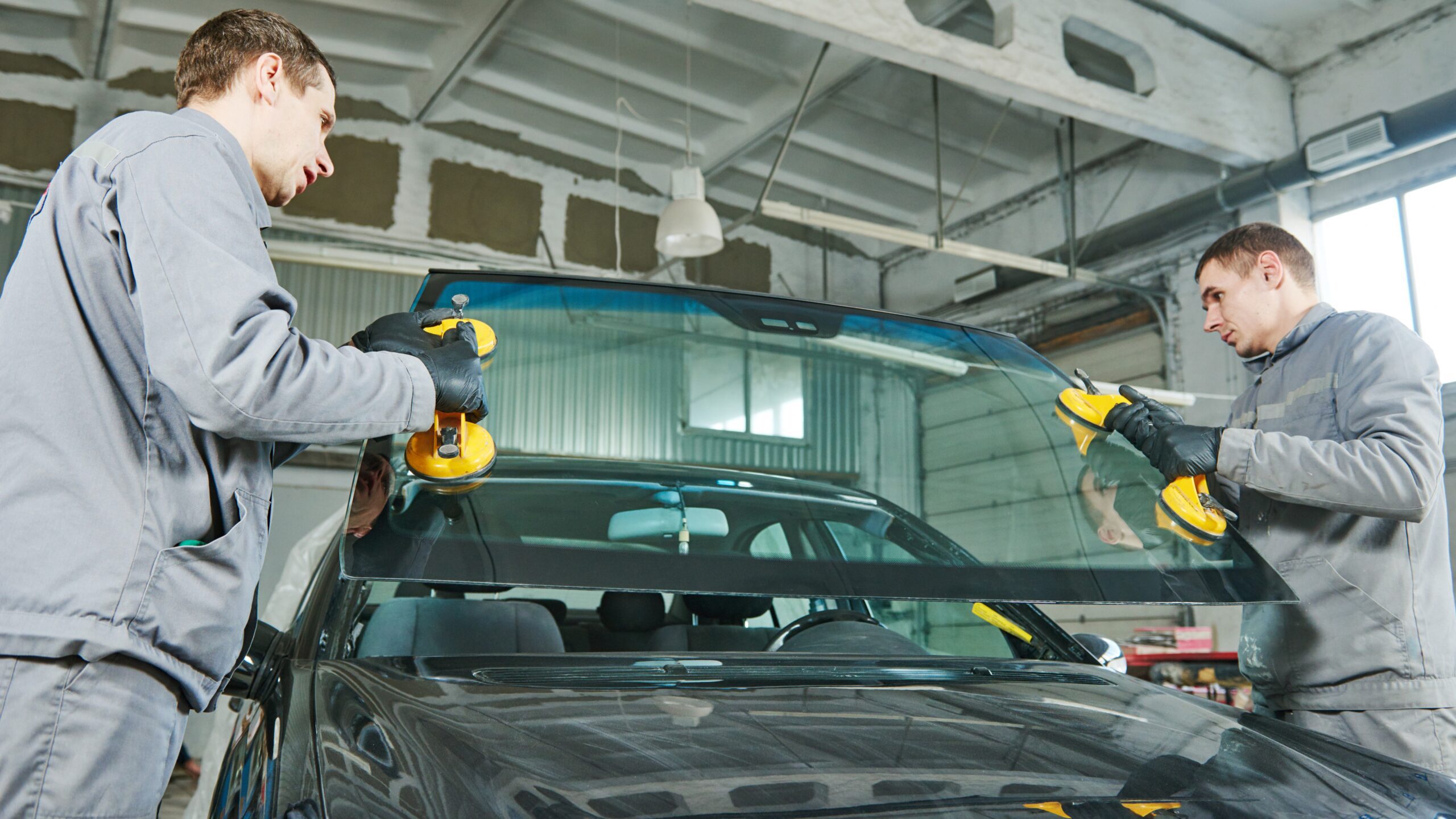 Auto glass team installing a new windshield