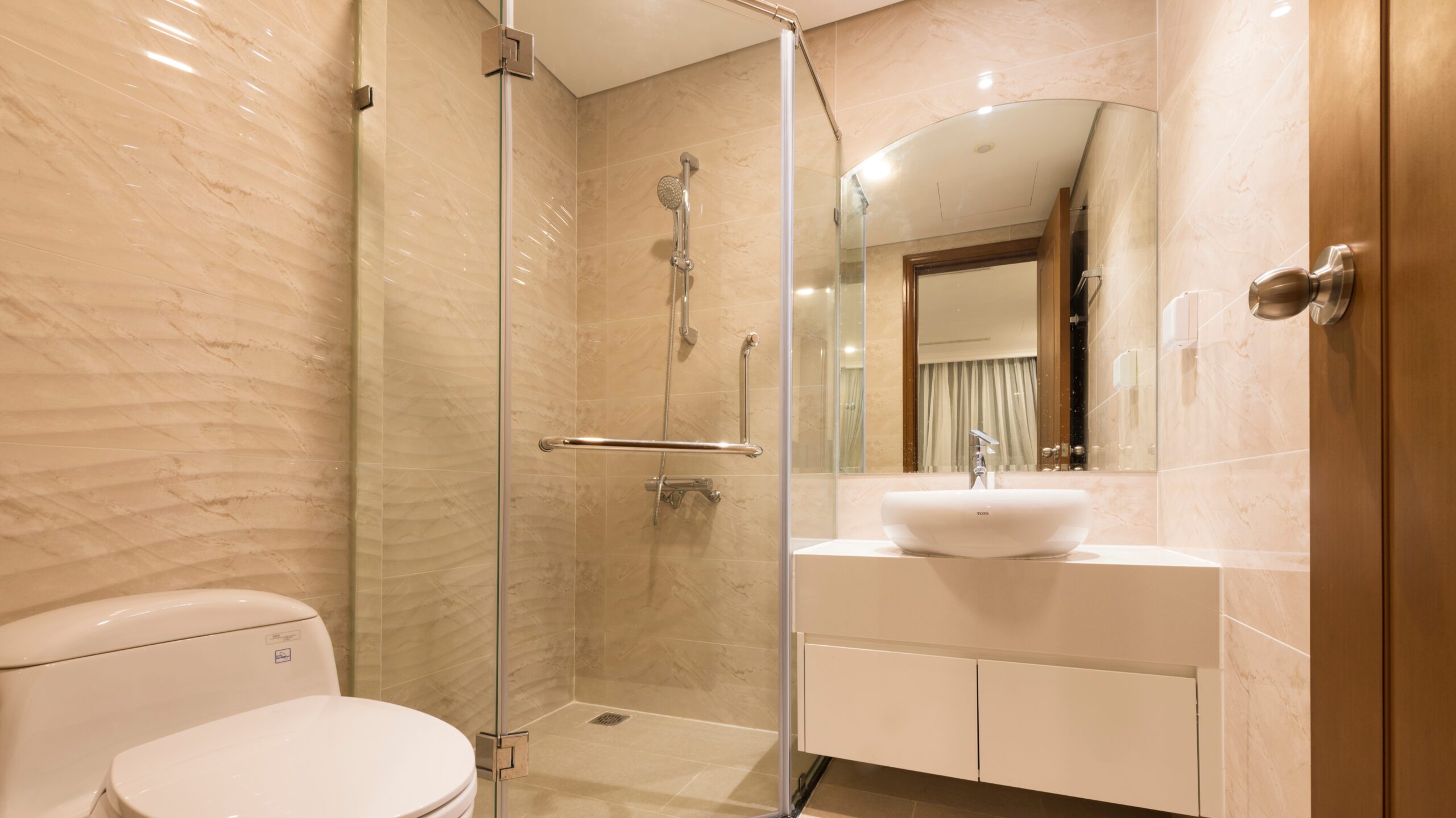 Modern bathroom remodel with beautiful white sink and new shower door enclosure